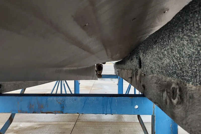 Slide: The Image of 1988 Shamrock 220 Predator boat hull on blue support stand. - 18