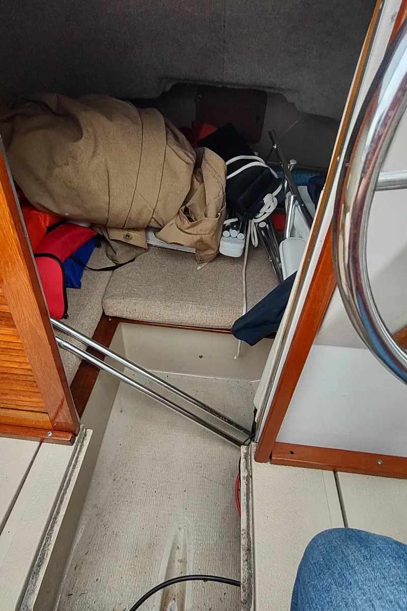 Slide: The Image of Interior cabin of 1988 Shamrock 220 Predator boat with scattered items. - 19
