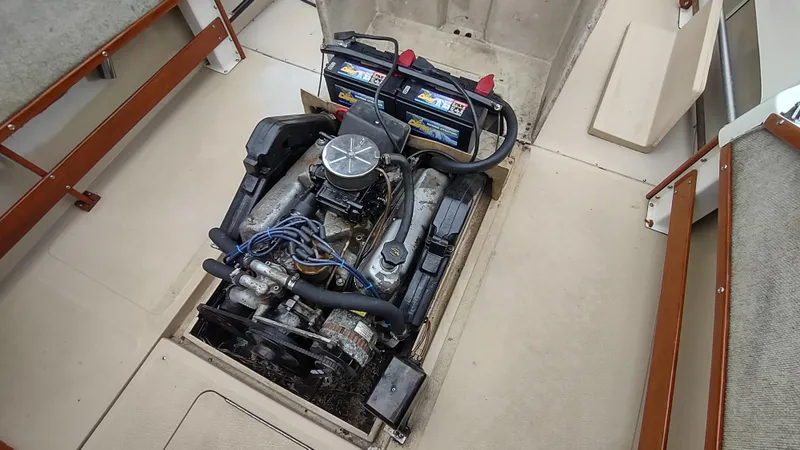 Slide: The Image of Engine compartment of a 1988 Shamrock 220 Predator boat, featuring dual batteries. - 8