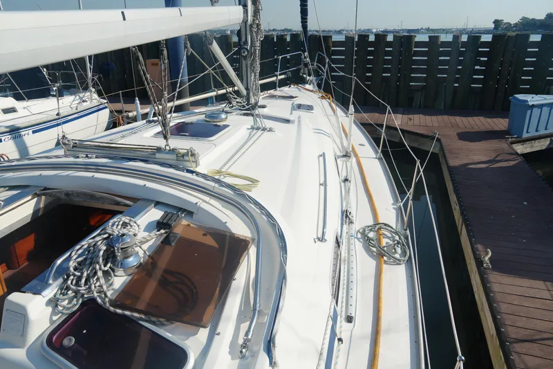 Slide: The Image of 2007 Bavaria 37 Cruiser sailboat docked at marina, showcasing deck and rigging. - 10