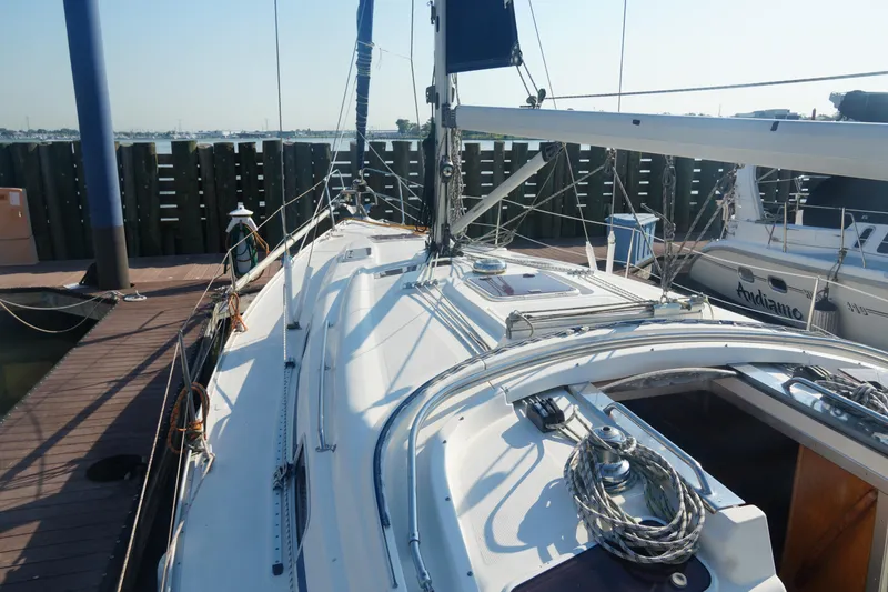 Slide: The Image of 2007 Bavaria 37 Cruiser sailboat docked at marina, showcasing deck and rigging. - 11