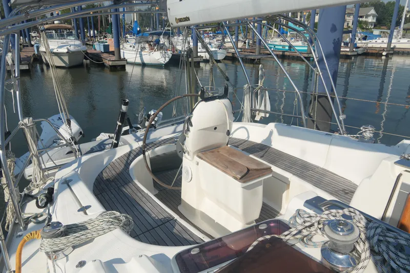 Slide: The Image of Cockpit of 2007 Bavaria 37 Cruiser yacht docked at marina, featuring steering wheel and seating. - 12