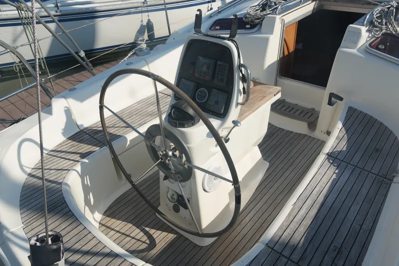 Slide: The Image of Cockpit of 2007 Bavaria 37 Cruiser sailboat with steering wheel and navigation instruments. - 13
