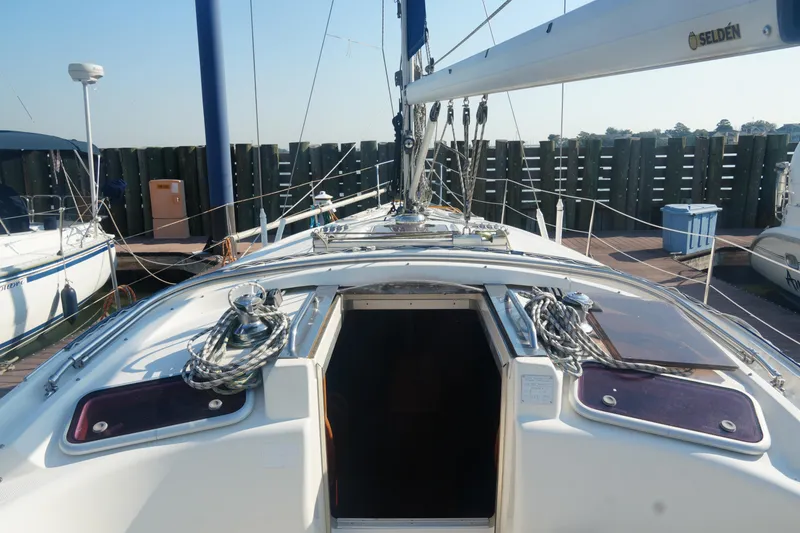 Slide: The Image of 2007 Bavaria 37 Cruiser sailboat docked, showing deck and open cabin entrance. - 14