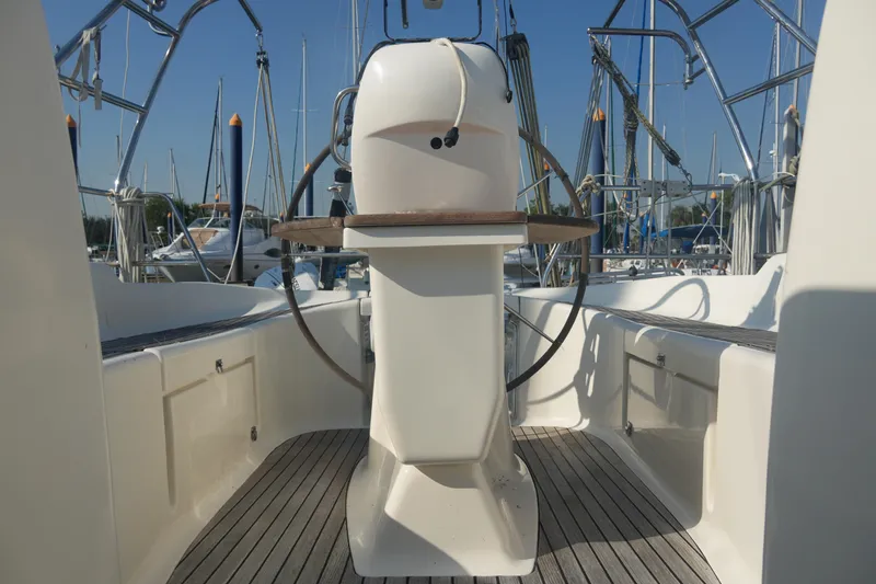 Slide: The Image of Cockpit of 2007 Bavaria 37 Cruiser sailboat with steering wheel and marina background. - 15