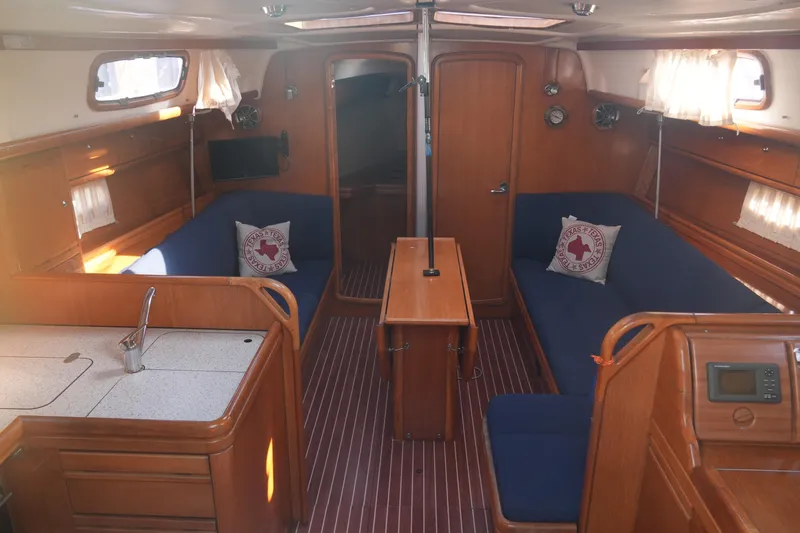 Slide: The Image of Interior of 2007 Bavaria 37 Cruiser yacht with wooden finish and blue seating. - 16