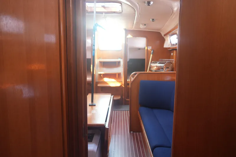 Slide: The Image of Interior of 2007 Bavaria 37 Cruiser yacht with wooden finish and blue seating. - 18