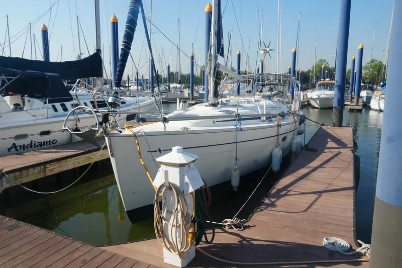 The Image of 2007 Bavaria 37 Cruiser yacht docked at marina with other sailboats. - 2