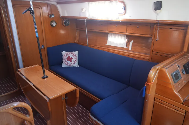 Slide: The Image of Interior of 2007 Bavaria 37 Cruiser yacht with blue seating and wooden cabinetry. - 20