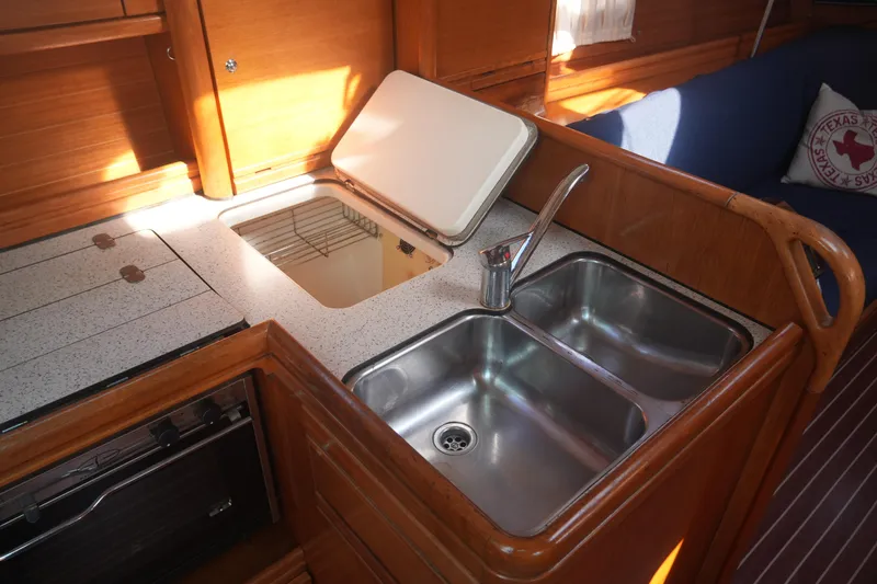 Slide: The Image of Interior of 2007 Bavaria 37 Cruiser yacht kitchen with double sink and wooden cabinetry. - 24