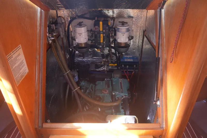 Slide: The Image of Engine compartment of a 2007 Bavaria 37 Cruiser sailboat, showcasing mechanical components. - 28