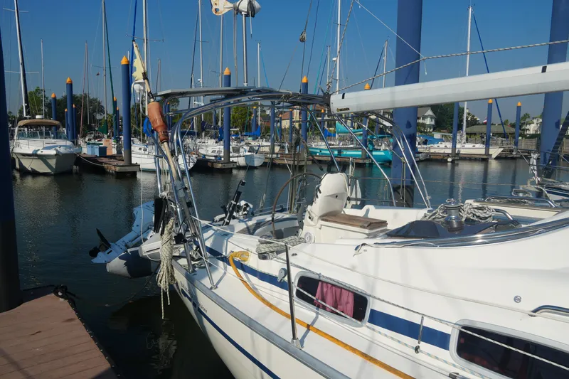 Slide: The Image of 2007 Bavaria 37 Cruiser yacht docked in a marina, surrounded by other sailboats. - 5