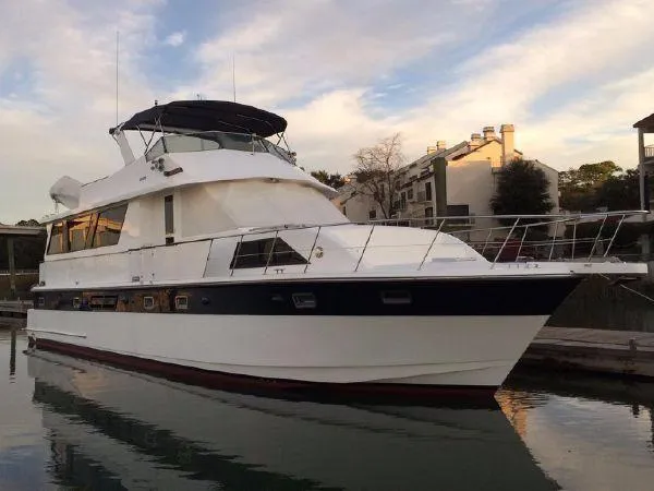 Slide: The Image of 1999 Jefferson Marquessa 56 yacht docked at marina under a partly cloudy sky. - 0