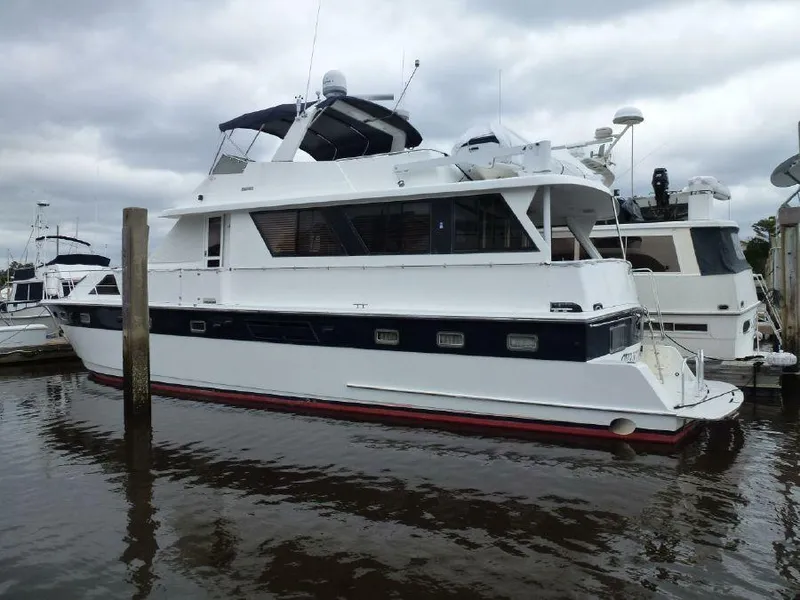 Slide: The Image of 1999 Jefferson Marquessa 56 yacht docked in a marina under cloudy skies. - 1