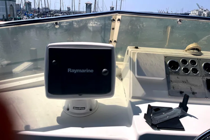 Slide: The Image of Cockpit of 1999 Jefferson Marquessa 56 with Raymarine navigation system and marina view. - 10