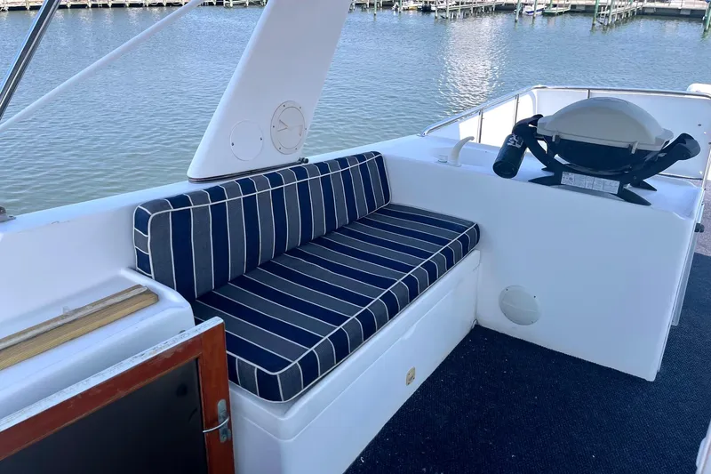 Slide: The Image of Deck seating area on a 1999 Jefferson Marquessa 56 yacht with striped cushions. - 12