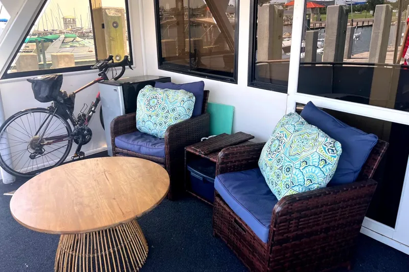 Slide: The Image of Cozy seating area on 1999 Jefferson Marquessa 56 yacht with wicker chairs and decorative cushions. - 19