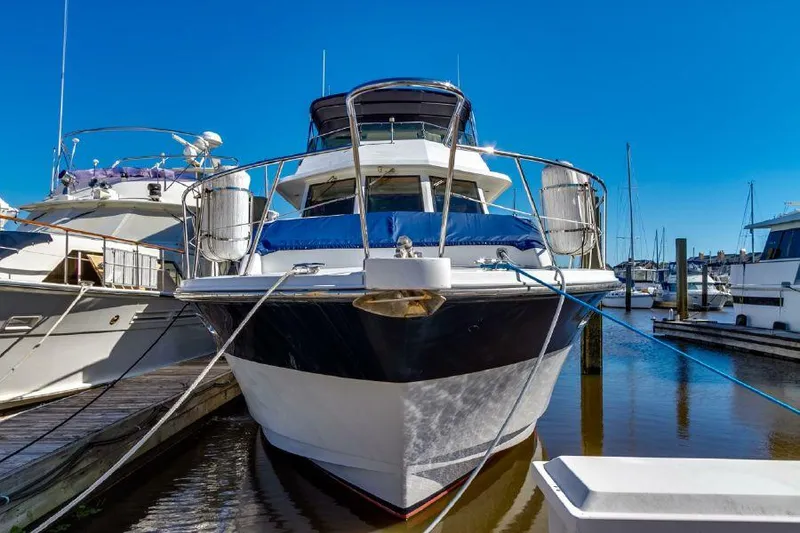 Slide: The Image of 1999 Jefferson Marquessa 56 yacht docked in marina under clear blue sky. - 2