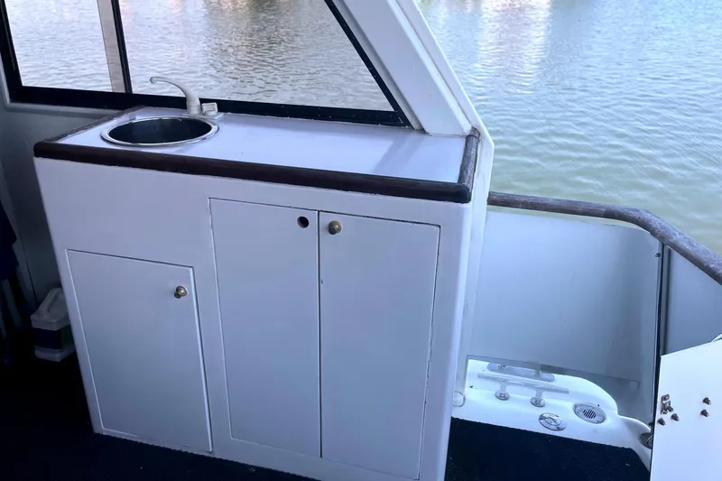 Slide: The Image of Kitchen area on a 1999 Jefferson Marquessa 56 yacht with sink and cabinets. - 21