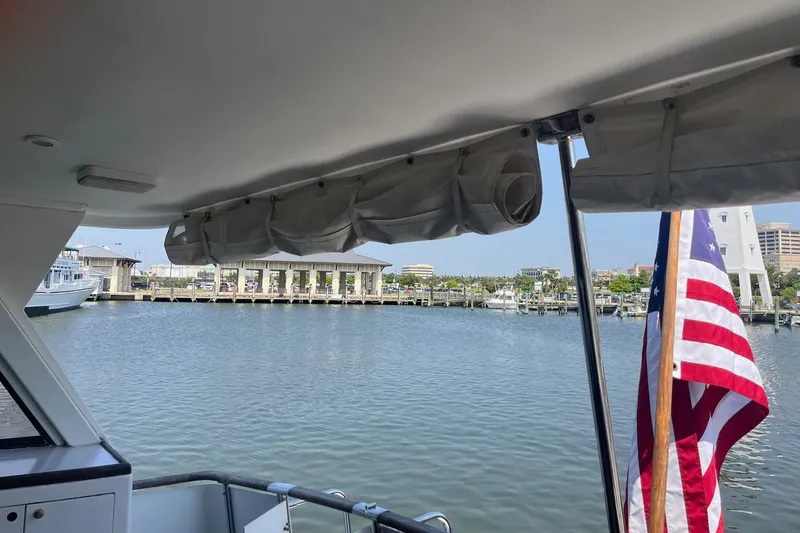 Slide: The Image of View from Jefferson Marquessa 56 yacht, American flag, marina backdrop, sunny day, 1999 model. - 22