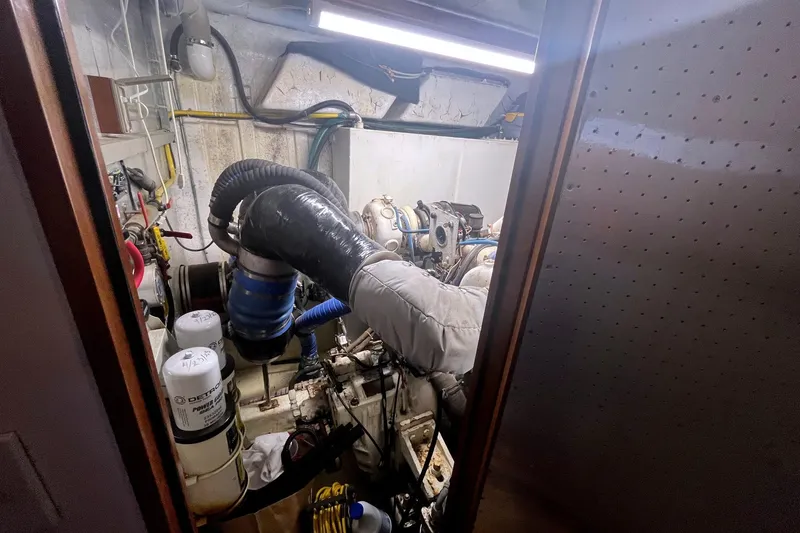 Slide: The Image of Engine room of a 1999 Jefferson Marquessa 56 yacht, featuring mechanical components and piping. - 26