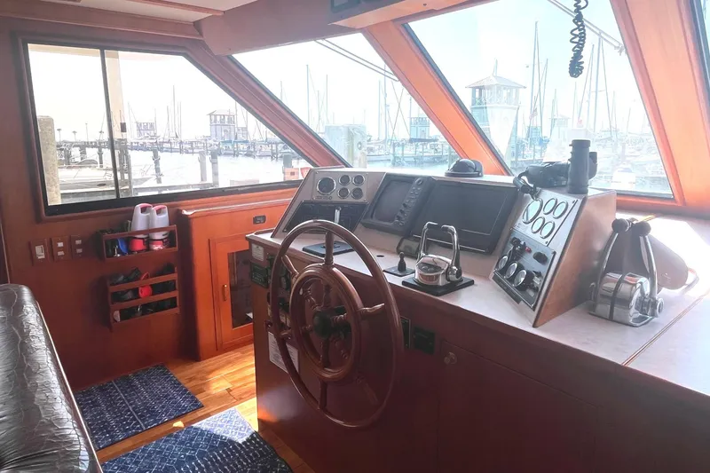 Slide: The Image of Helm of 1999 Jefferson Marquessa 56 yacht with marina view through windows. - 29