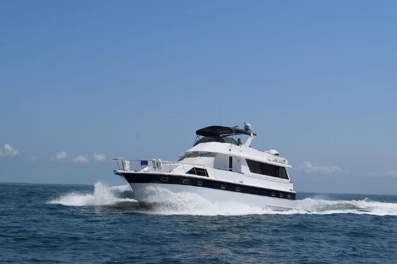 Slide: The Image of 1999 Jefferson Marquessa 56 yacht cruising on open water under clear blue sky. - 3