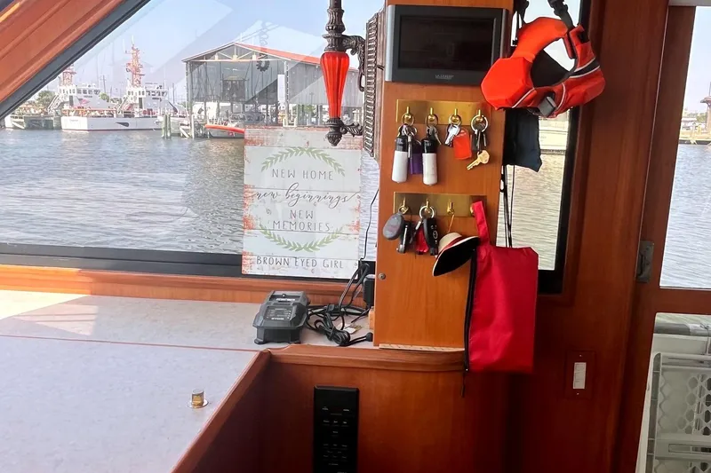 Slide: The Image of Interior of 1999 Jefferson Marquessa 56 boat with keys, life jacket, and waterfront view. - 30