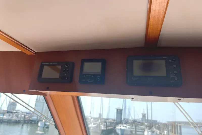 Slide: The Image of Control panel inside a 1999 Jefferson Marquessa 56 yacht, overlooking a marina. - 33