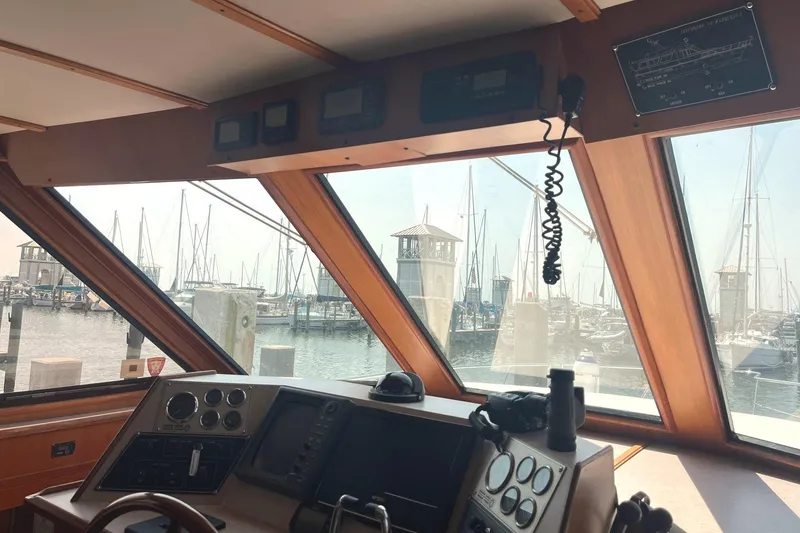 Slide: The Image of Interior view of 1999 Jefferson Marquessa 56 yacht helm with marina backdrop. - 34