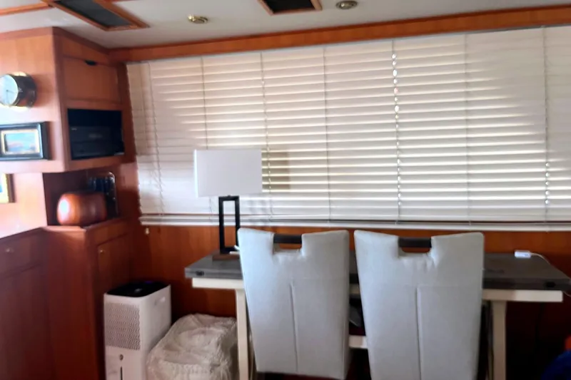 Slide: The Image of Interior of 1999 Jefferson Marquessa 56 yacht with blinds, chairs, and a table lamp. - 38