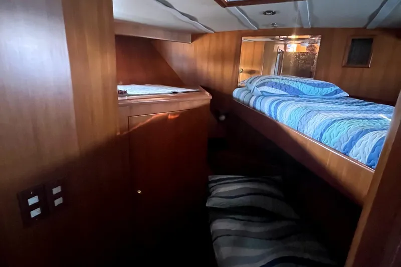 Slide: The Image of Cozy cabin interior of 1999 Jefferson Marquessa 56 yacht with wooden paneling and blue bedding. - 50