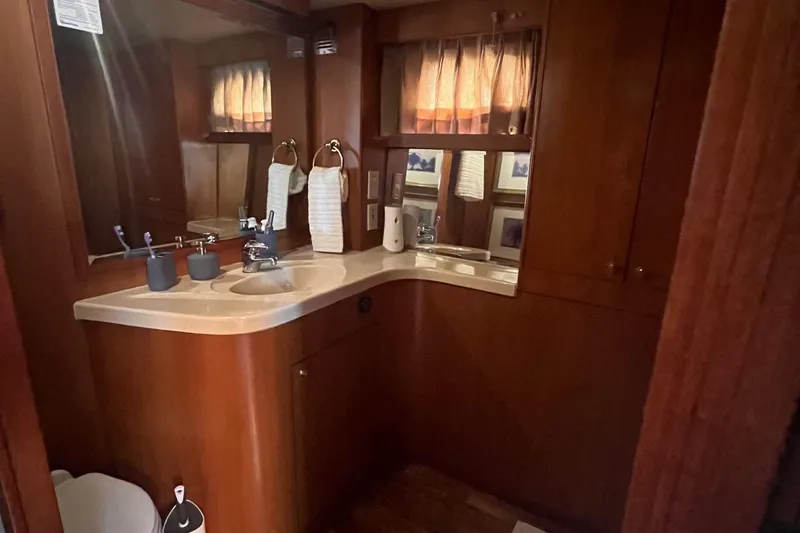 Slide: The Image of Bathroom interior of 1999 Jefferson Marquessa 56 yacht with wooden cabinetry and modern fixtures. - 52
