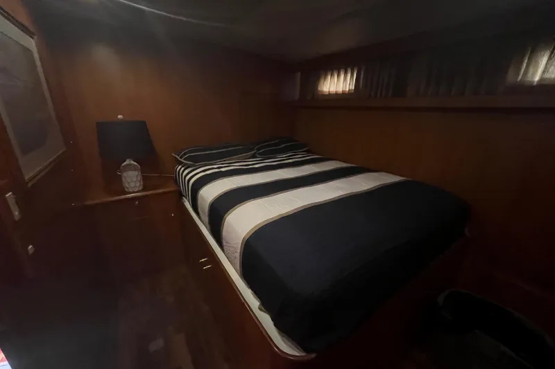 Slide: The Image of Cozy bedroom interior of 1999 Jefferson Marquessa 56 yacht with striped bedding and lamp. - 55