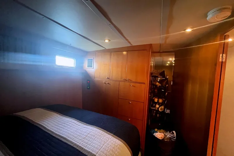 Slide: The Image of Cozy bedroom interior of 1999 Jefferson Marquessa 56 yacht with wooden cabinetry. - 57