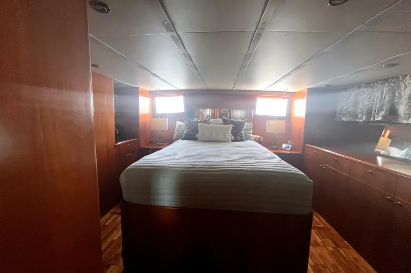 Slide: The Image of Luxurious bedroom interior of 1999 Jefferson Marquessa 56 yacht with wood paneling and cozy bedding. - 59