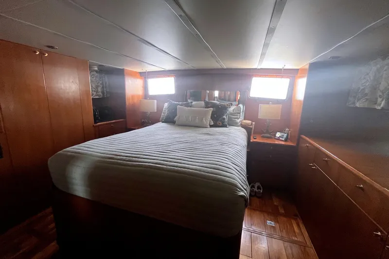 Slide: The Image of Cozy bedroom interior of 1999 Jefferson Marquessa 56 yacht with wood paneling and natural light. - 61