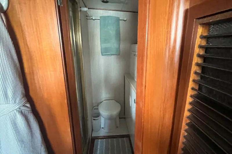 Slide: The Image of Bathroom interior of 1999 Jefferson Marquessa 56 yacht, featuring wooden accents and compact design. - 64