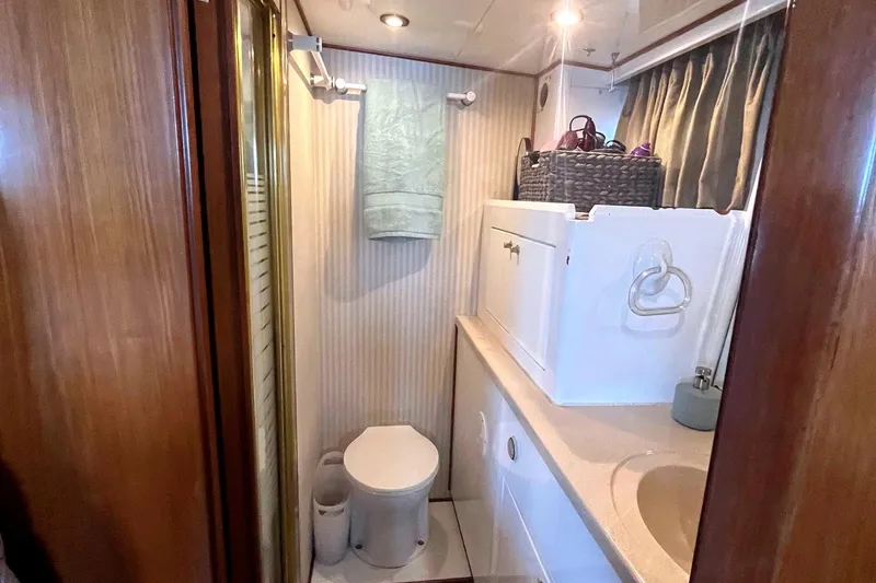 Slide: The Image of Bathroom interior of 1999 Jefferson Marquessa 56 yacht, featuring shower, toilet, and sink. - 65