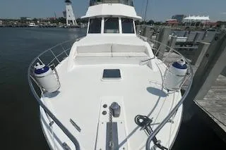 Slide: The Image of 1999 Jefferson Marquessa 56 yacht docked at marina with lighthouse in background. - 7