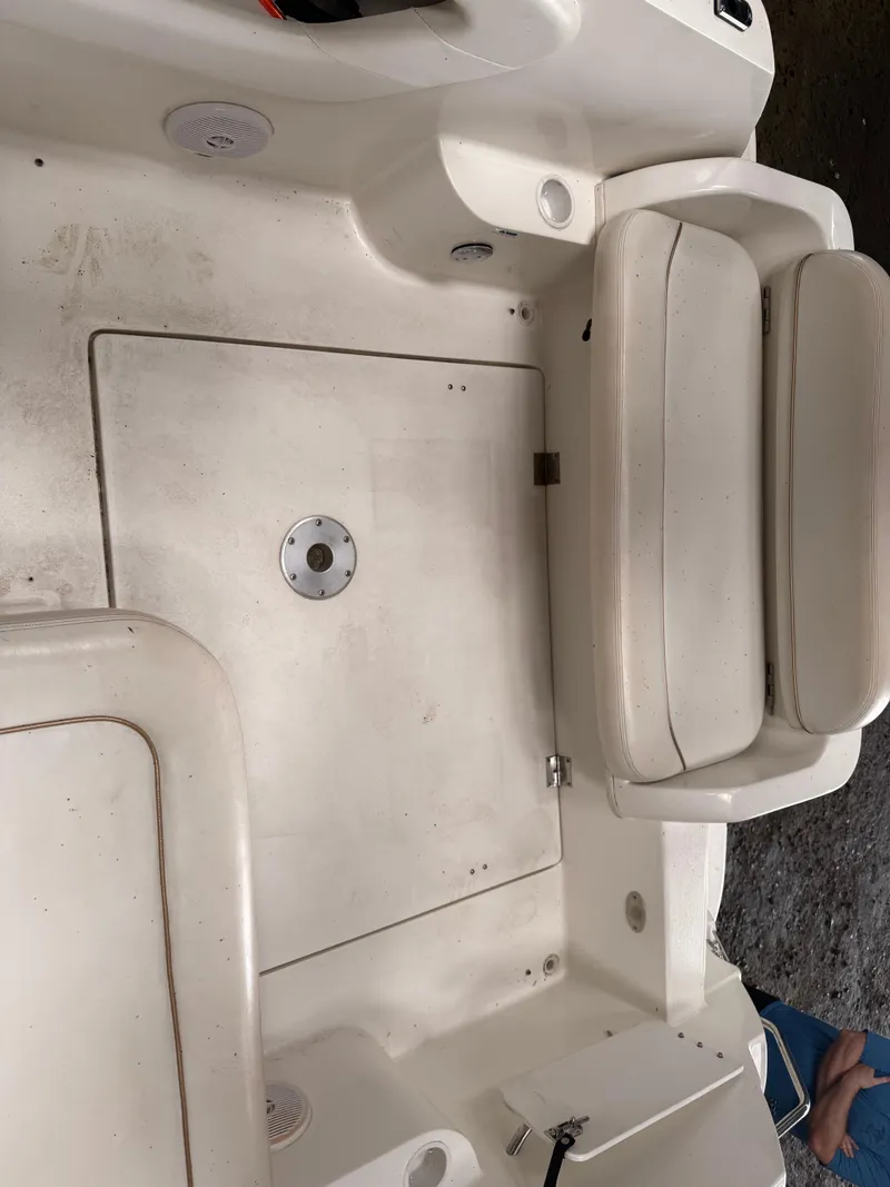 Slide: The Image of 2001 Wellcraft 2600 Martinique boat interior with white seating and storage compartments. - 11