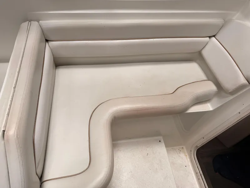 Slide: The Image of 2001 Wellcraft 2600 Martinique boat interior seating with white upholstery. - 13