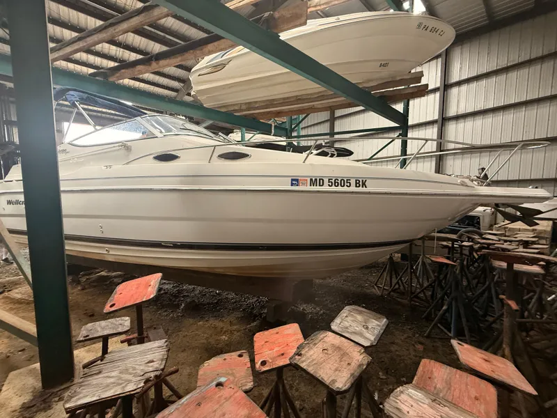 Slide: The Image of 2001 Wellcraft 2600 Martinique boat stored indoors on stands. - 3