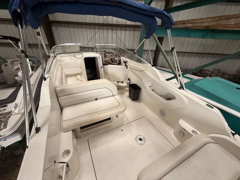 Slide: The Image of 2001 Wellcraft 2600 Martinique boat interior with seating and steering wheel, under blue canopy. - 4