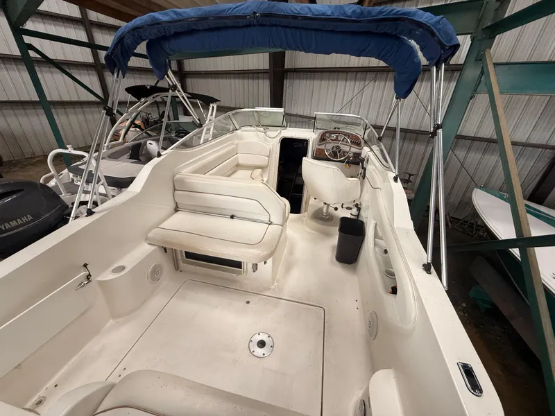 Slide: The Image of 2001 Wellcraft 2600 Martinique boat interior with seating and steering wheel, under blue canopy. - 5