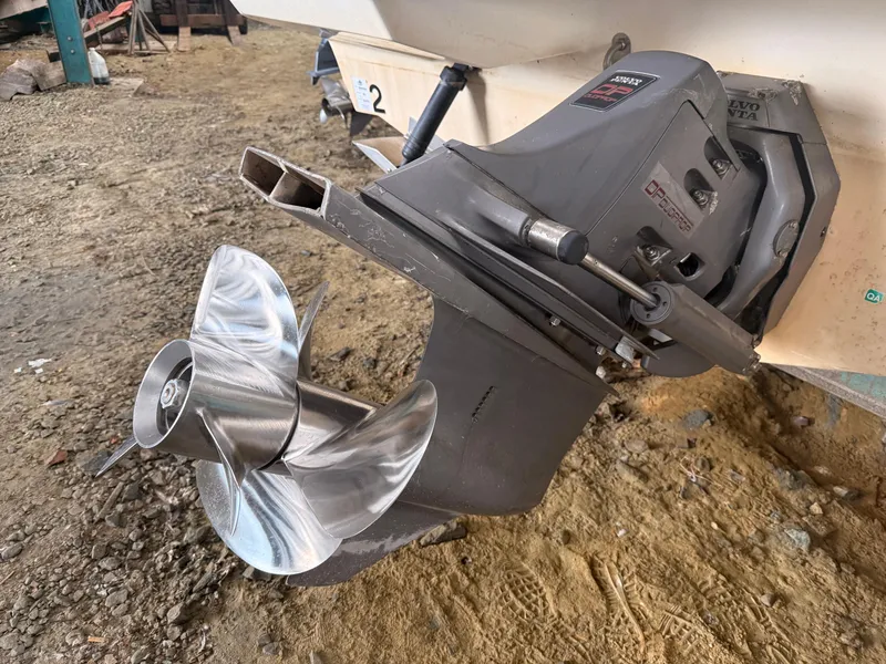 Slide: The Image of 2001 Wellcraft 2600 Martinique boat propeller and outdrive on dry ground. - 7