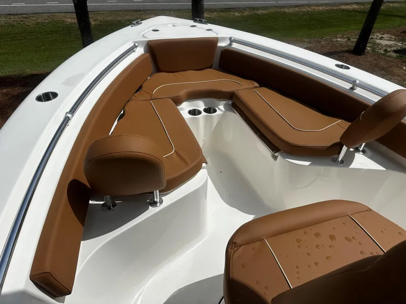 Slide: The Image of 2025 Key West 219fs boat interior with brown seating and cup holders. - 12
