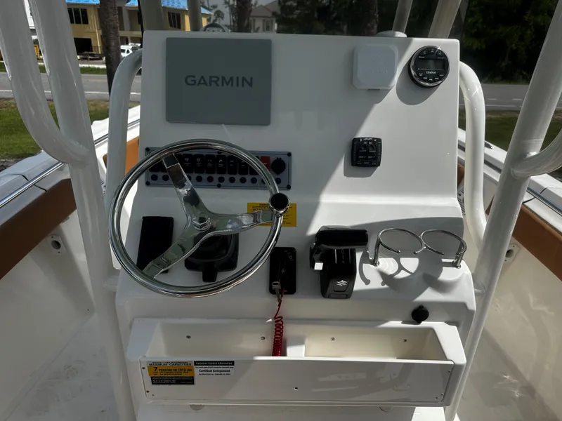 Slide: The Image of 2025 Key West 219fs boat console with Garmin navigation and steering wheel. - 13