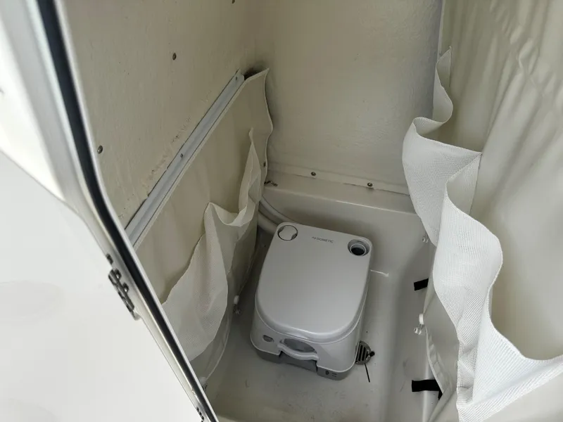 Slide: The Image of Portable toilet inside a 2025 Key West 219fs boat compartment. - 5