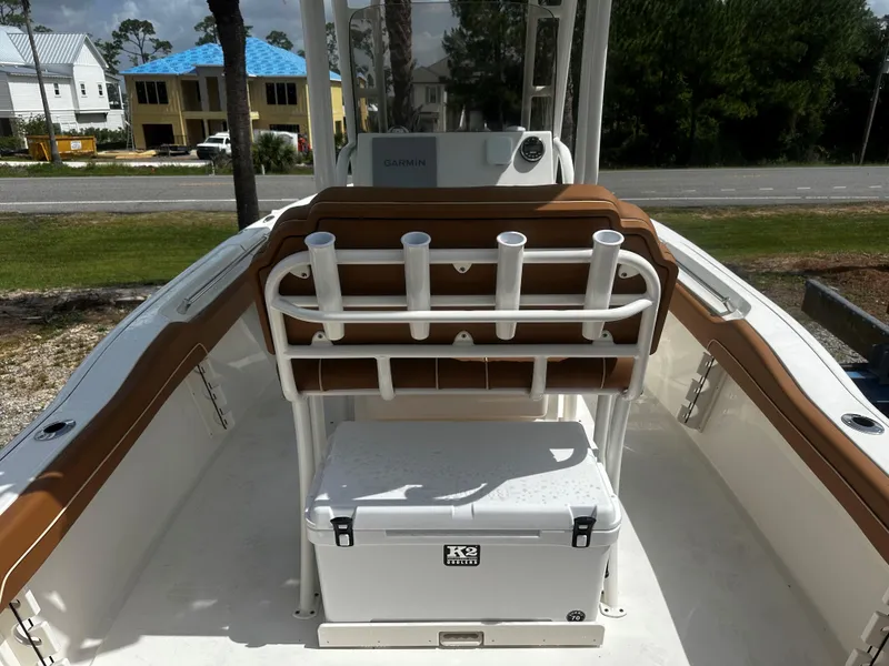 Slide: The Image of 2025 Key West 219fs boat interior with rod holders and cooler on deck. - 9